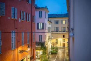 a view from a window of an alley with buildings at Appartamento San Giovanni - centro storico di Parma in Parma