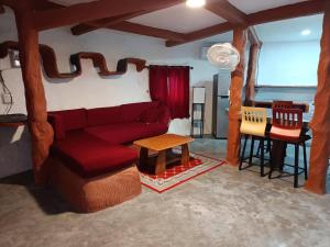 a living room with a red couch and a table at Art rock garden in Ko Lipe