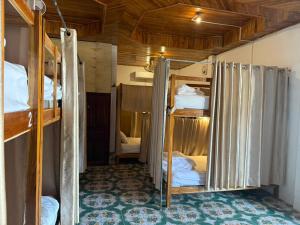 a room with two bunk beds in a room at KP Backpackers Hostel in Nongkhiaw