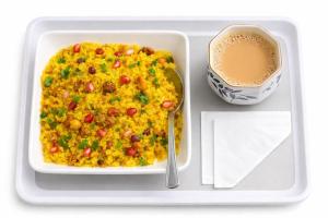 a tray with a plate of food and a cup of coffee at Hotel Manas Inn in Ayodhya