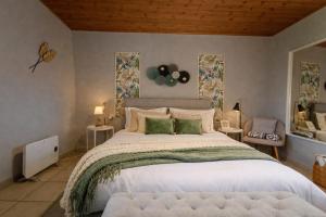 a bedroom with a large bed with green pillows at Nafplio Cottage-Grandma's Yard in Asíni