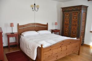 a bedroom with a large bed and two night stands at Mezzodì Locazione Turistica in Colcerver