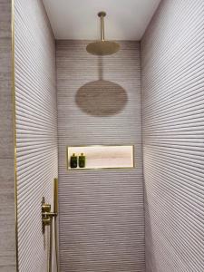 a bathroom with a shower stall with a shower at Connemara Sands Hotel & Spa in Clifden