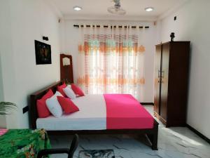 a bedroom with a large bed and a window at OCEAN Wild Trail in Hikkaduwa