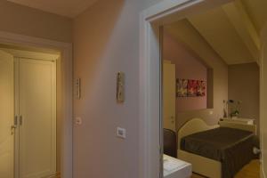 Postel nebo postele na pokoji v ubytování Hotel Arnolfo & Aqua Laetitia Spa & Beauty