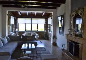 a living room with a couch and a fireplace at Dimitra's Villa in Evia, Greece in Loukísia