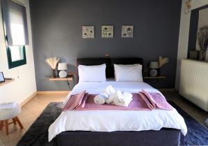 a bedroom with a large bed with towels on it at Dimitra's Villa in Evia, Greece in Loukísia +13 photos