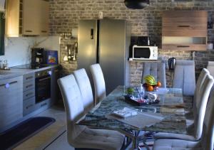 a kitchen with a table with chairs and a counter top at Dimitra's Villa in Evia, Greece in Loukísia