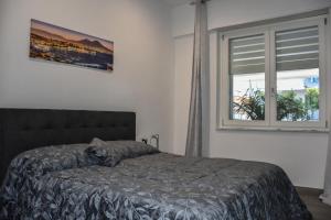 a bedroom with a bed with a cat sleeping on it at House Nonno Viky in Volla