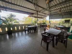 a restaurant with tables and chairs and a patio at Serenity Sunrise Beach Resort in Pondicherry