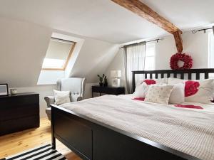 a bedroom with a large bed with red and white pillows at Venkovský Útulek in Lázně Libverda