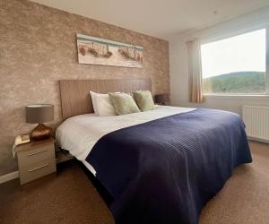 a bedroom with a large bed and a window at Cullen Bay Hotel in Cullen