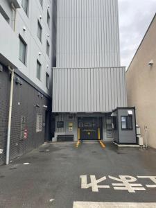 an empty parking lot in front of a building at Dormy Inn Morioka in Morioka +53 photos