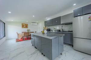 a kitchen with stainless steel appliances and a counter top at Villa Oberon in Oberon