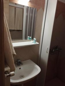 a small bathroom with a sink and a mirror at Filoxenia Marias in Loutra Ipatis +32 photos