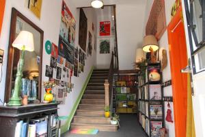 a staircase in a room with bookshelves at Les chambres noires in Mélisey