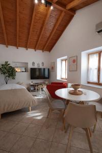 a living room with a bed and a table and chairs at Nafplio Nook in Nafplio