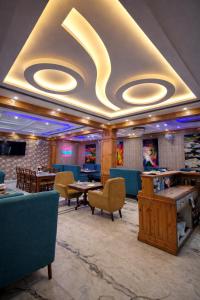 a restaurant with tables and chairs in a room at The Asanar Hills in Rūpnagar