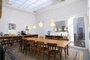 a kitchen with a large wooden table and chairs at LA MAISON FIVES - Esprit Hôtel Design - Lille in Lille
