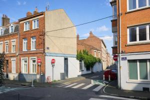 an empty street in a town with brick buildings at LA MAISON FIVES - Esprit Hôtel Design - Lille in Lille