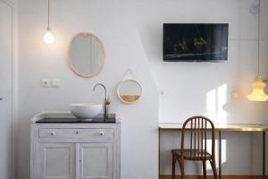a bathroom with a sink and a table and a chair at LA MAISON FIVES - Esprit Hôtel Design - Lille in Lille +57 photos