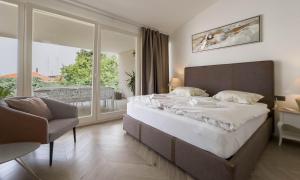 a bedroom with a large bed and a balcony at Villa Damiani " Partys and loud music forbidden!!!" in Pula +63 photos