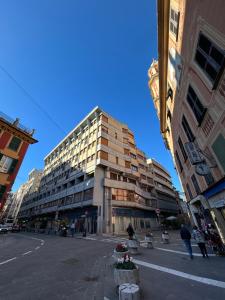 a tall building on a city street with buildings at Palma Residence Rapallo by PortofinoVacanze in Rapallo