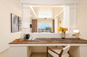 a kitchen with a counter with a vase of flowers at Diamonds Bijoux in Bwejuu