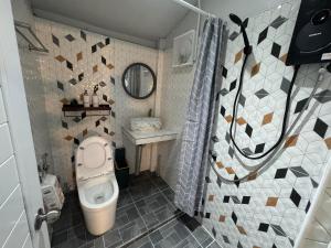 a bathroom with a toilet and a sink at Primmy house kohtao in Ko Tao +42 photos
