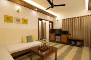 a living room with a couch and a table at Hanu Reddy Residences, Poes Garden - Boutique Urban Retreat in Chennai