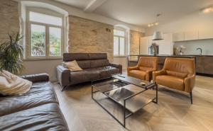 a living room with two couches and a table at Villa Damiani " Partys and loud music forbidden!!!" in Pula
