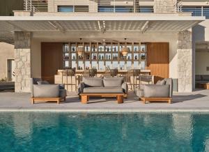 a swimming pool with two lounge chairs and a table at WAM by Karma in Bodrum City