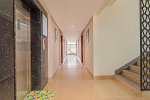 a hallway of a house with stairs and a rug at Treebo Premium Cachet Suites in Coimbatore