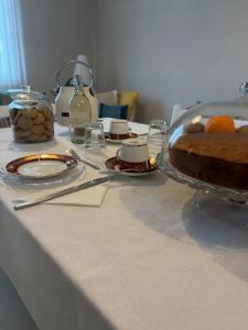 a table with a cake and other food on it at B&B Le Saline Bed & Breakfast in Cervia