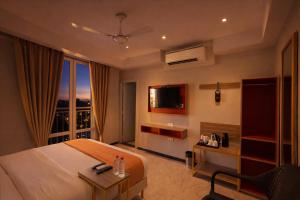 a hotel room with a bed and a balcony at Phoenix Unmatched Comfort - Hotel Near Fateh Sagar Lake Udaipur in Udaipur +14 photos
