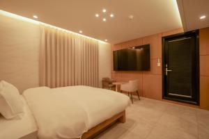 a hotel room with a bed and a television at 잠실 라운지 호텔 in Seoul