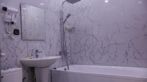 a bathroom with a sink and a tub and a toilet at Old Well Hotel in Tsaghkadzor +46 photos