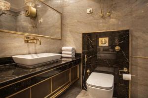 a bathroom with a sink and a toilet and a mirror at Velocity Corporate Hotel TERMINAL 2,3 Delhi Airport With- Free Airport Pickup in New Delhi +20 photos