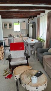 a living room with a couch and a kitchen with a table at Topli Kutak in Blatina