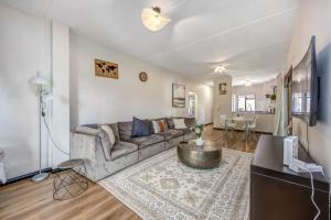 a living room with a couch and a table at Tashy Luxury 2 bedroomed apartment in Johannesburg