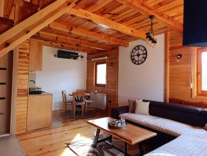 a living room with a couch and a table at Vila Sofija Mokra Gora in Mokra Gora
