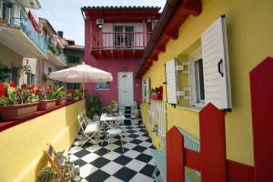 a courtyard of a building with a table and an umbrella at "Wonderland" Nest Nafplio in Nafplio