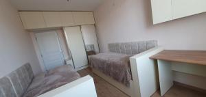 a small bedroom with a bed and a mirror at Moreni house in Gavarr
