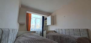 two beds in a room with a window at Moreni house in Gavarr