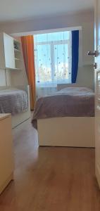 a bedroom with two beds and a window at Moreni house in Gavarr