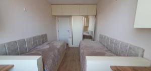 a living room with two couches and a bedroom at Moreni house in Gavarr