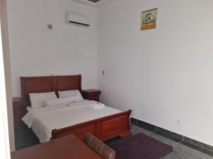 a bedroom with a bed and a chair at ADM HOTEL Grand-Lahou in Grand-Lahou +25 photos