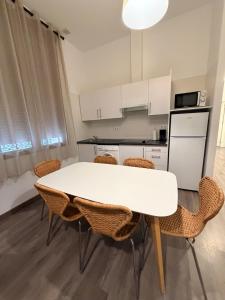 a kitchen with a white table and chairs at Zerka Sendra in Valencia +59 photos