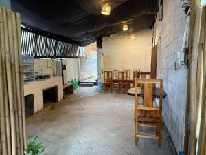 an empty room with chairs and a table in it at KP Backpackers Hostel in Nongkhiaw