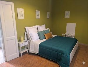 a bedroom with a large bed with green walls at Corte Meneghina-short stays in Buscate